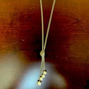 Set of silver tone, knotted pearl necklace with matching earrings